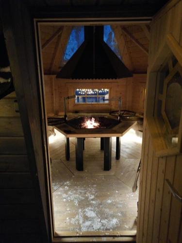 a room with a table with a fire in it at Villa Nietos in Rovaniemi