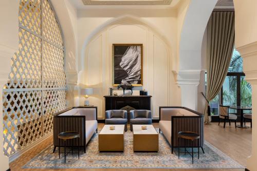 a living room with two couches and a table at Palace Downtown in Dubai