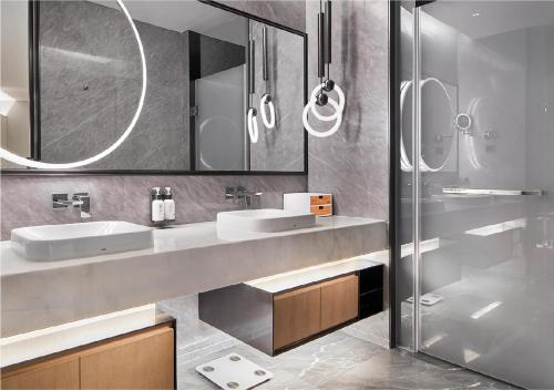 a bathroom with two sinks and a shower at EVEN Hotel Nanjing Yangtze River by IHG in Nanjing