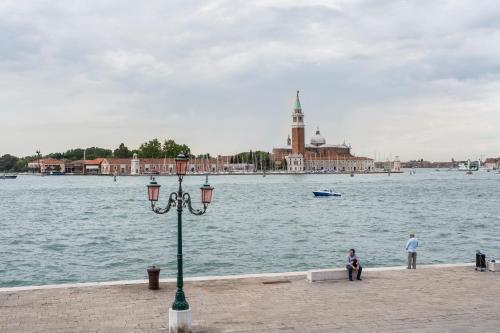 a street light next to a body of water at Hotel Bucintoro in Venice