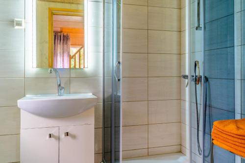a bathroom with a sink and a shower at Metsaääre Accommodation in Uulu