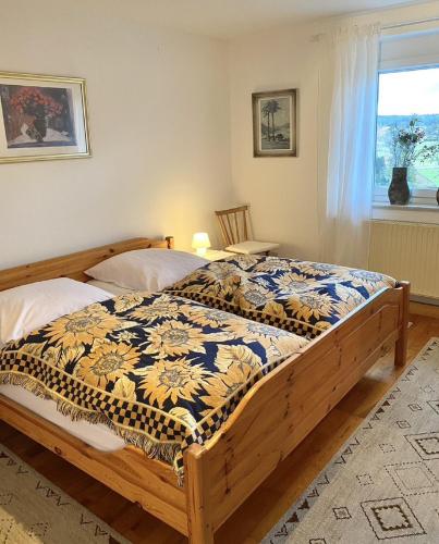 a bedroom with a bed with a quilt on it at Ferienwohnungen Anna Altmann in Furth im Wald
