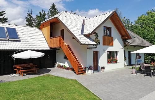 a home with a patio and a house at PR`Cajhn in Radovljica