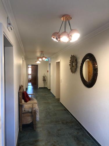 a hallway with a couch and a mirror on the wall at Landhaus Kössel in Füssen