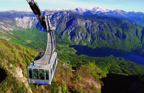 a gondola is flying over a mountain at PR`Cajhn in Radovljica