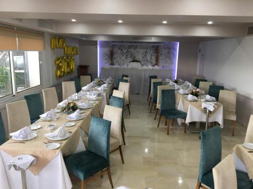 a dining room with long tables and green chairs at hôtel LE PACHA in Tunis