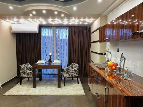 a kitchen with a table and a dining room at Sky Apartments Special in Strumica