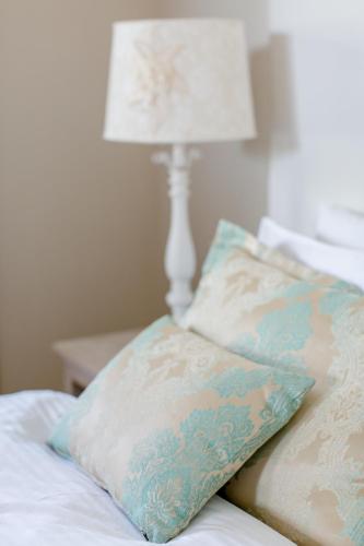 a bed with two pillows and a lamp on it at Club Hotel Barbarossa in Kas