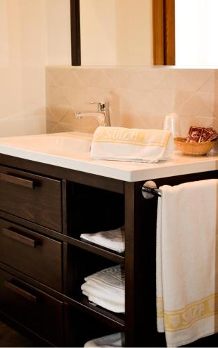 a bathroom with a sink and a counter with towels at Hotel Suiza in Bronchales