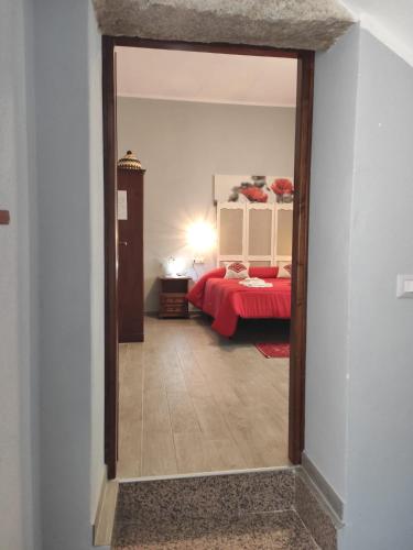 a view of a bedroom with a bed through a doorway at B&B Babay in Guspini