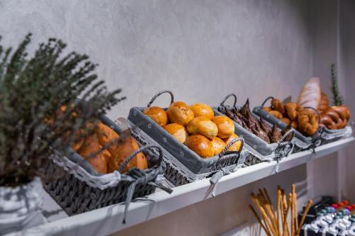 a shelf with baskets of oranges and other fruits at Art Deluxe Hotel in Tashkent