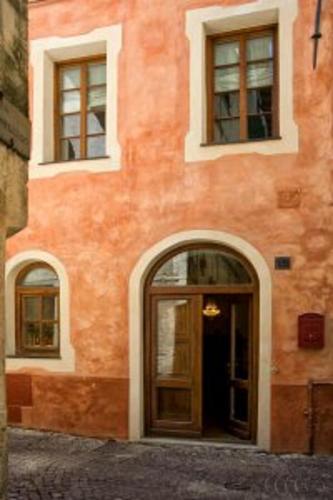 an orange building with a door and windows at CASA LEONE BADALUCCO in Badalucco