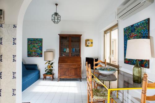 a living room with a blue couch and a window at Residence Degli Agrumi Mare in Taormina