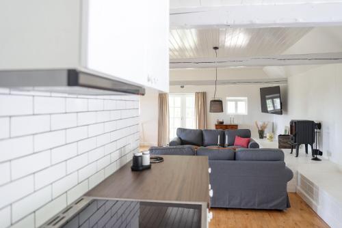 a living room with a couch and a table at Sandet in Borre