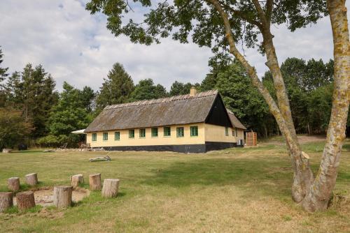 a building with a black roof in a field at Sandet in Borre