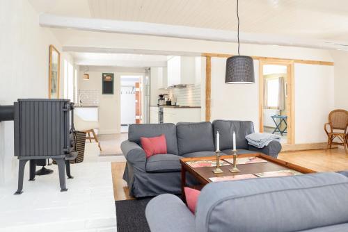 a living room with a couch and a table at Sandet in Borre