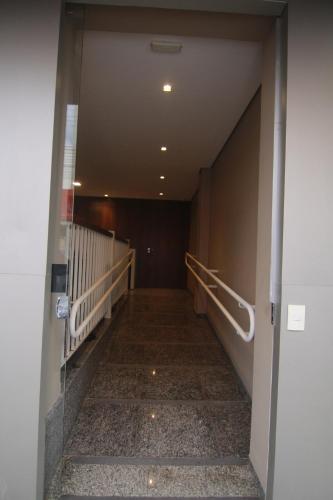 a hallway in an office building with stairs at Hotel Alpha in Uberlândia
