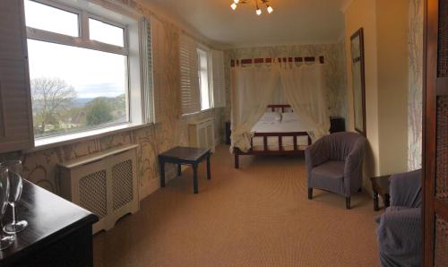 a bedroom with a bed and a window at The Moorland Hotel in Wotter