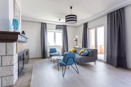 a living room with a couch and chairs and a fireplace at Apartments Bella Vista - Mlini in Mlini