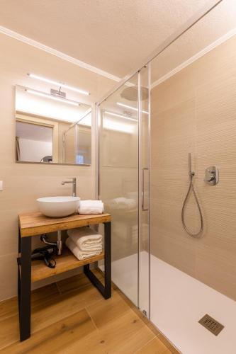 a bathroom with a sink and a shower at Borgo Cantagallo Casa Olivia 1 in Tremosine Sul Garda