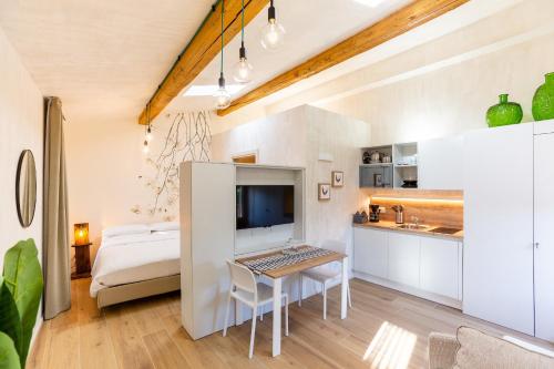 a room with a desk and a bed and a kitchen at Borgo Cantagallo Casa Olivia 2 in Tremosine Sul Garda