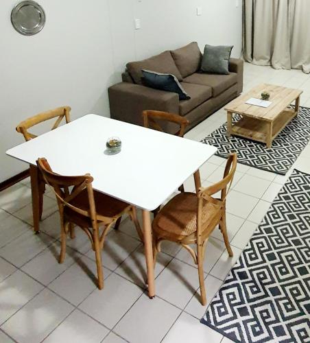 a living room with a white table and chairs at Laboria 102 & 103 in Harrismith