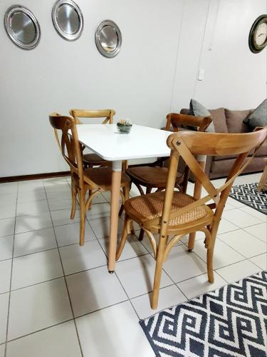 a dining room with a white table and chairs at Laboria 102 & 103 in Harrismith