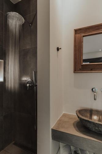 a bathroom with a sink and a shower at Villa Panorama in Paleros