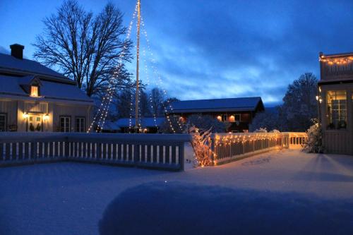 a house with christmas lights in a yard at Wanbo Herrgård in Nedre Vanbo