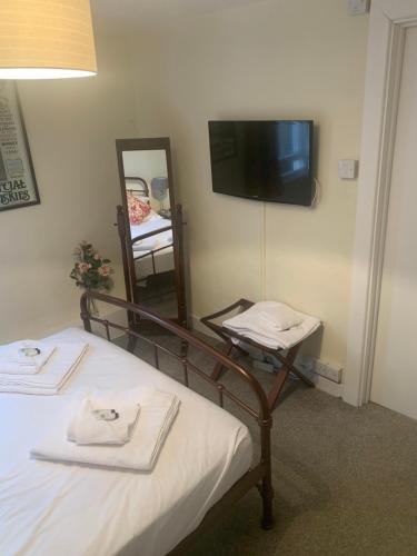 a hotel room with a bed and a mirror at The Ship Inn Fowey in Fowey