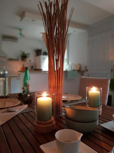 a wooden table with candles on top of it at B&B Soissons L'Arthome chambres d'hôtes in Mercin-et-Vaux