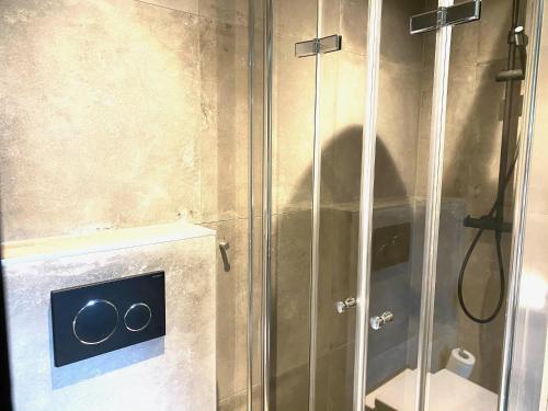 a shower with a glass door with aaucet at Hotel de Prince in Nijmegen