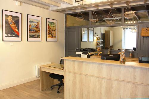 a restaurant with a reception counter and a mirror at Hôtel des Bateliers in La Malène