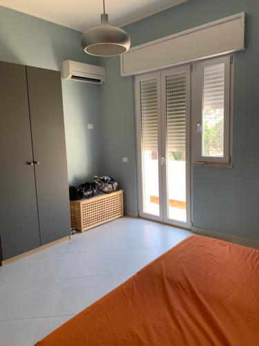 an empty room with a bed and a window at appartamento VENTO in Pulsano
