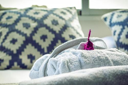 a person sitting on a couch with a towel at YOU & CO. Saler Beach Boutique in Valencia