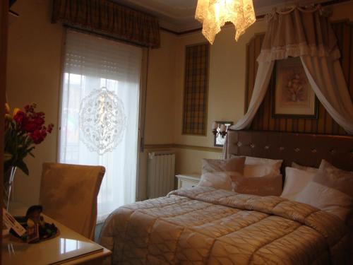 a bedroom with a bed and a table and a window at Hotel Vandelli in Pavullo nel Frignano
