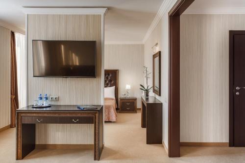 a hotel room with a television on a wall at Carat by Undersun in Krasnodar