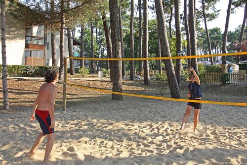 two children playing in a volley ball net on the beach at Azureva Ronce les Bains in Ronce-les-Bains