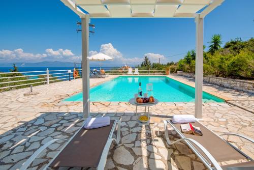 a swimming pool with a view of the ocean at The Kantada Villas Petros, Eleni, Stelios & Dioni in Gaios