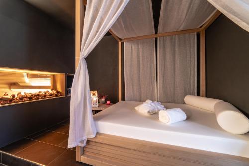 a bedroom with a bed with two towels on it at HB Aosta Hotel & Balcony SPA in Aosta