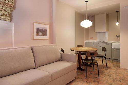 a living room with a couch and a table at Pamplonapartments Pozo Blanco in Pamplona