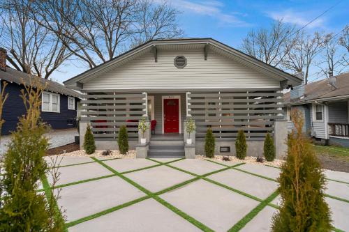 a house with a red door and a garage at Charlotte Luxury Home NoDa in Charlotte