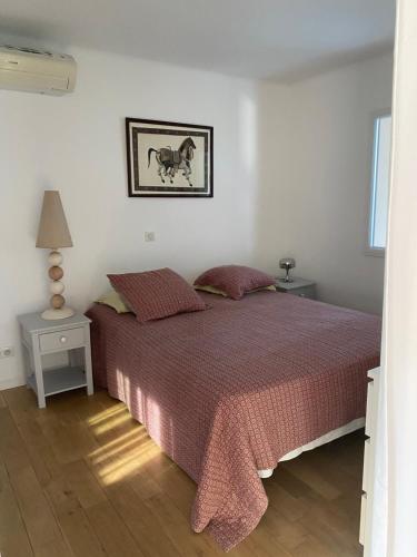 une chambre avec un lit avec une couette rouge dans l'établissement Le murât, à Six-Fours-les-Plages