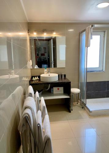 a bathroom with a sink and a mirror at Charming Lido Flat I in Funchal