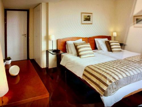 a bedroom with a large bed with pillows at Charming Lido Flat I in Funchal