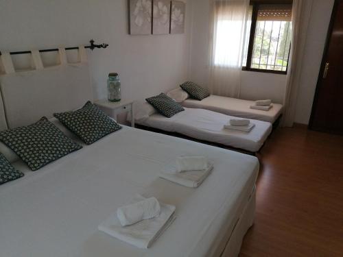 a room with two beds with towels on them at Chalet Puerto Marina Goya in Benalmádena