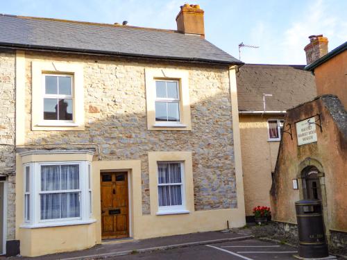an old stone house with white windows at Harbour Cottage in Watchet