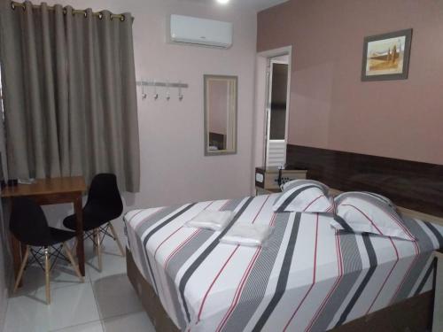 Una cama o camas en una habitación de Hotel Faf's Interlagos - SP
