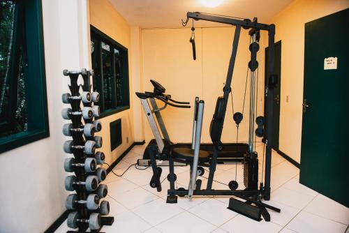 a room with a gym with a chair and weights at Urikana Boutique Hotel in Teresópolis