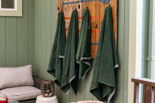 a group of green towels hanging on a wall at Artist's Perch in Guerneville